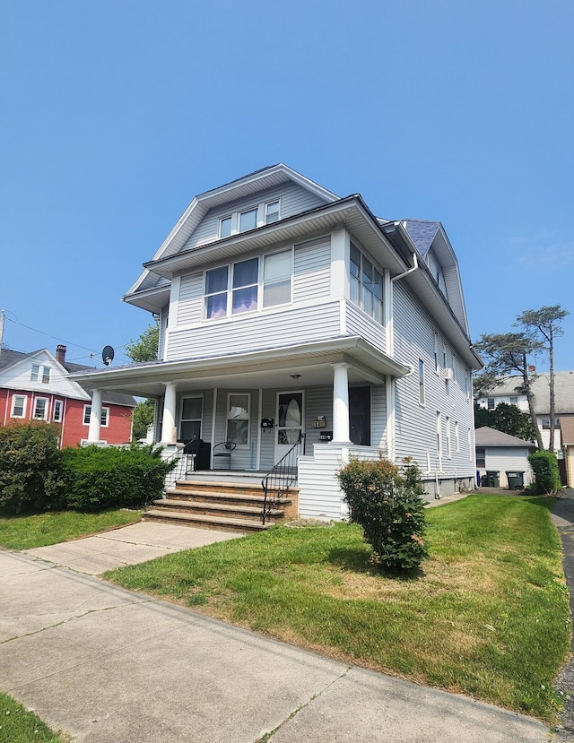 64 Wade St, Bridgeport, CT 06604 - american foursquare style home featuring a front lawn and covered porch