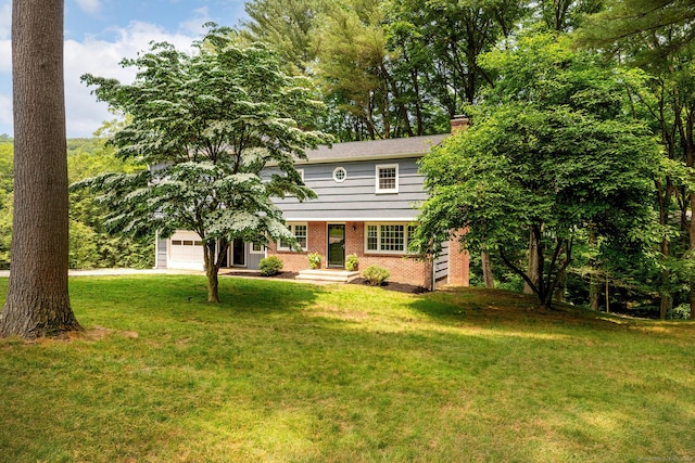 39 Aspen Mill Rd, Ridgefield, CT 06877 - view of front facade with brick siding, a front yard, a chimney, driveway, and a garage