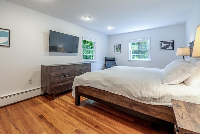 39 Aspen Mill Rd, Ridgefield, CT 06877 - bedroom featuring light wood finished floors, multiple windows, and a baseboard radiator