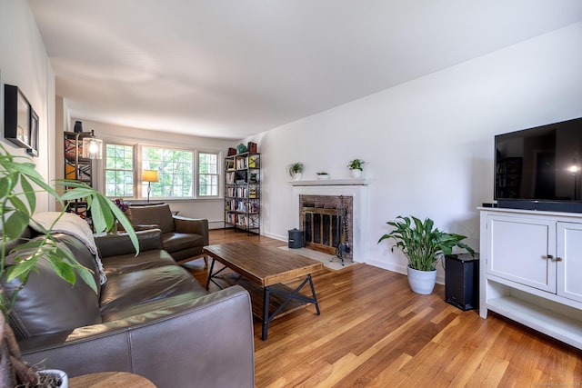 39 Aspen Mill Rd, Ridgefield, CT 06877 - living area featuring light wood-type flooring, a brick fireplace, and baseboard heating