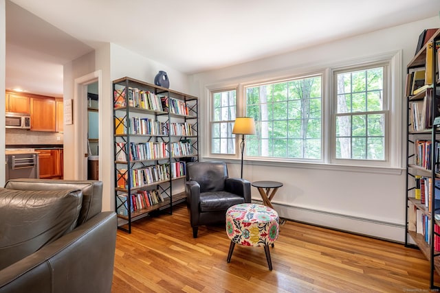 39 Aspen Mill Rd, Ridgefield, CT 06877 - sitting room with a baseboard heating unit and light wood-style floors