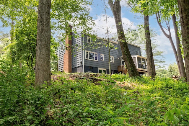 39 Aspen Mill Rd, Ridgefield, CT 06877 - back of house with a chimney, a sunroom, and a deck