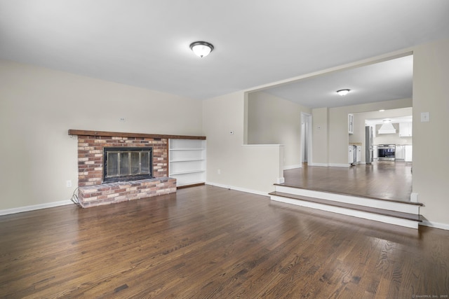 5 Skiff Pkwy, North Haven, CT 06473 - unfurnished living room featuring a brick fireplace and wood finished floors