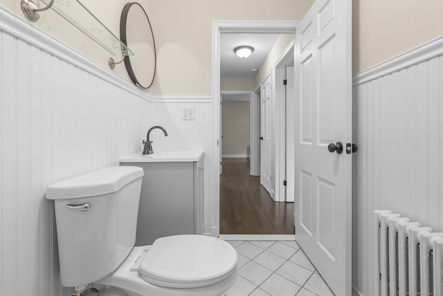 5 Skiff Pkwy, North Haven, CT 06473 - bathroom with radiator heating unit, wainscoting, and tile patterned flooring