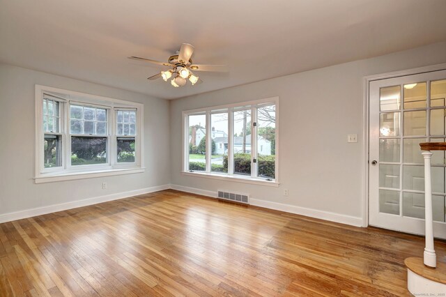 30 Birch St, Stratford, CT 06615 - unfurnished room with healthy amount of natural light, light wood finished floors, and ceiling fan