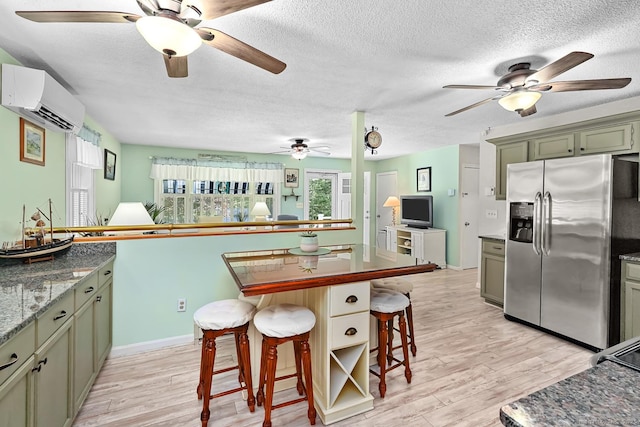 47 Little Bungee Hill Rd, Woodstock, CT 06282 - kitchen with stainless steel fridge, a wall unit AC, a ceiling fan, a kitchen breakfast bar, and a textured ceiling