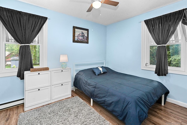 47 Little Bungee Hill Rd, Woodstock, CT 06282 - bedroom featuring a baseboard radiator, multiple windows, and wood finished floors