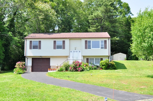8 Pons Rd, Groton, CT 06355 - split foyer home featuring asphalt driveway, an attached garage, a shed, and a front yard