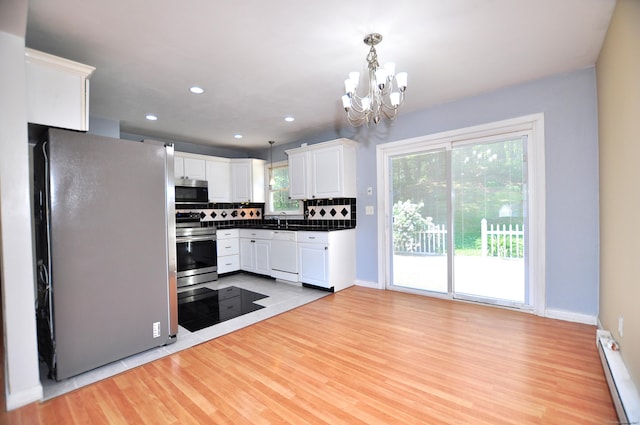 8 Pons Rd, Groton, CT 06355 - kitchen with stainless steel appliances, baseboard heating, a chandelier, light wood-style floors, and white cabinetry