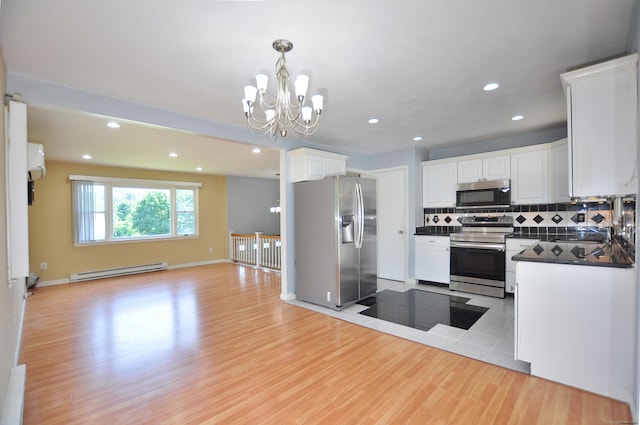 8 Pons Rd, Groton, CT 06355 - kitchen featuring stainless steel appliances, dark countertops, baseboard heating, open floor plan, and light wood-style flooring