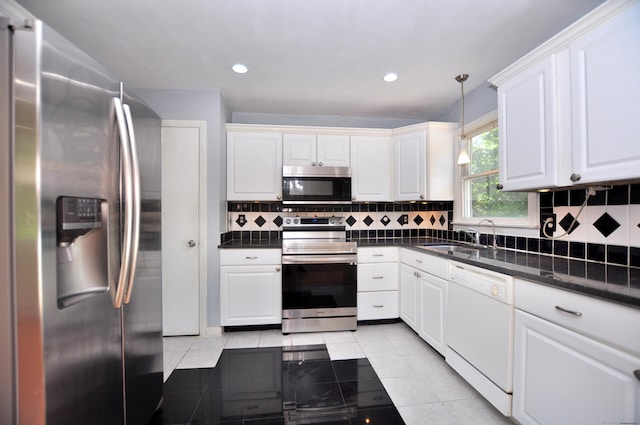 8 Pons Rd, Groton, CT 06355 - kitchen with stainless steel appliances, dark countertops, white cabinets, light tile patterned floors, and recessed lighting