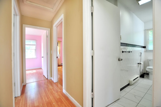8 Pons Rd, Groton, CT 06355 - hall featuring a baseboard heating unit, healthy amount of natural light, tile walls, and light wood-style floors