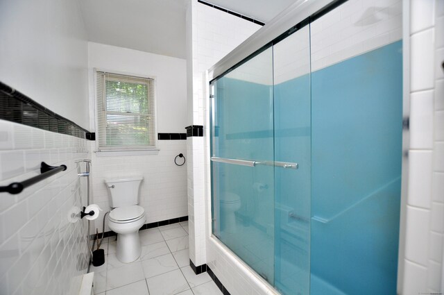 8 Pons Rd, Groton, CT 06355 - bathroom featuring an enclosed shower, tile walls, tile patterned flooring, and a wainscoted wall