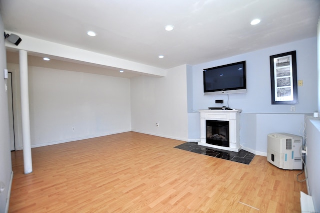 8 Pons Rd, Groton, CT 06355 - unfurnished living room featuring light wood-style floors, recessed lighting, and a glass covered fireplace