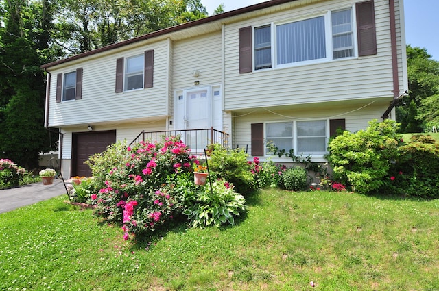 8 Pons Rd, Groton, CT 06355 - split foyer home featuring an attached garage, a front lawn, and asphalt driveway