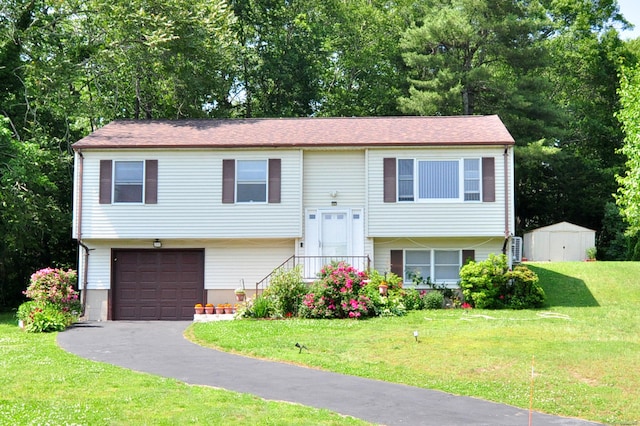 8 Pons Rd, Groton, CT 06355 - bi-level home featuring a garage, driveway, a storage shed, and a front yard