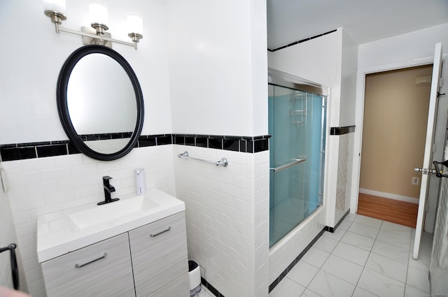 8 Pons Rd, Groton, CT 06355 - full bath featuring a shower with door, vanity, tile walls, marble look tiles, and a wainscoted wall