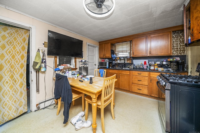 42 Goodwin St, Torrington, CT 06790 - kitchen featuring stainless steel appliances, dark countertops, crown molding, brown cabinetry, and light floors