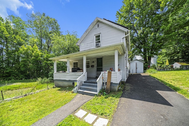 42 Goodwin St, Torrington, CT 06790 - shotgun-style home featuring covered porch, driveway, a shed, and a front yard