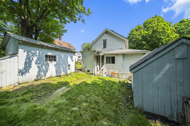 42 Goodwin St, Torrington, CT 06790 - back of house with entry steps, a storage shed, and a lawn