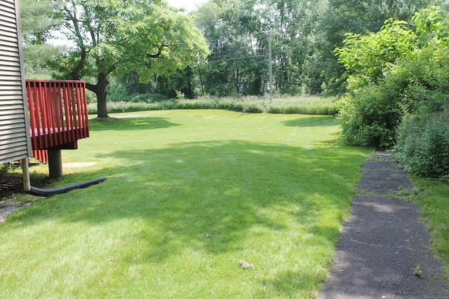 176 Atwater St Apt 7, Southington, CT 06479 - view of green lawn featuring view of wooded area and a wooden deck