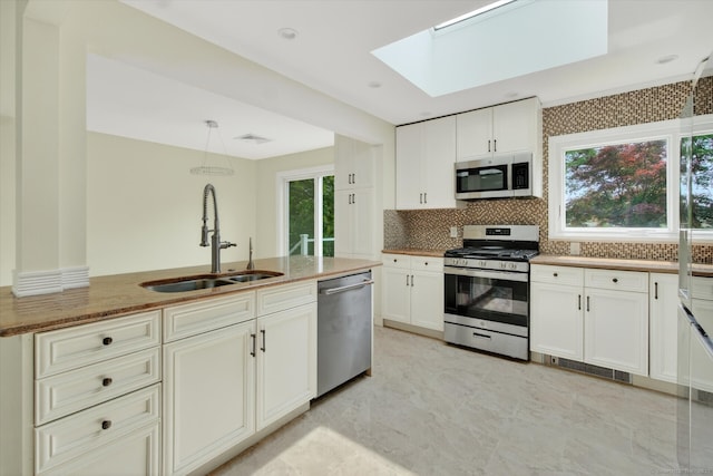 3481 Park Ave, Fairfield, CT 06825 - kitchen with appliances with stainless steel finishes, a skylight, backsplash, and plenty of natural light