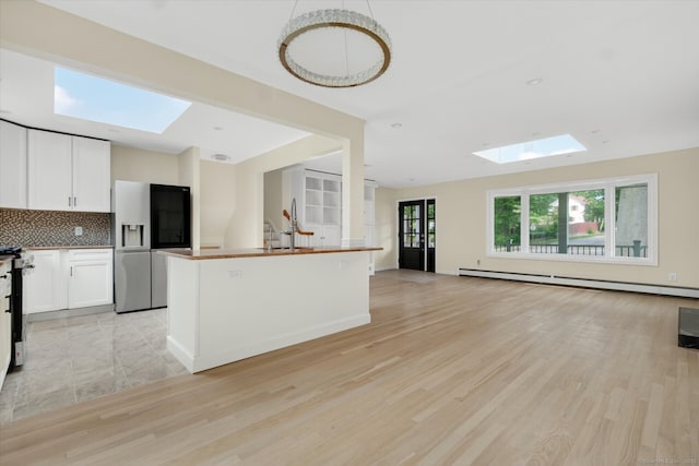 3481 Park Ave, Fairfield, CT 06825 - kitchen with a skylight, stainless steel appliances, baseboard heating, and open floor plan