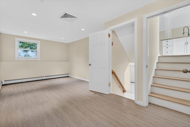 3481 Park Ave, Fairfield, CT 06825 - basement featuring a baseboard heating unit, wood finished floors, and recessed lighting