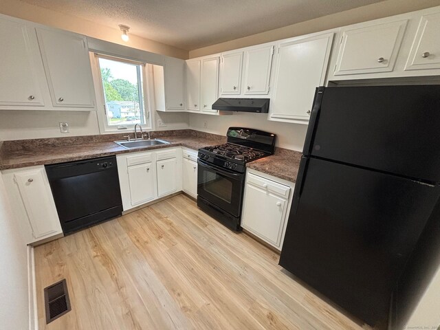 167 High Top Cir W Unit 167, Hamden, CT 06514 - kitchen with black appliances, under cabinet range hood, dark countertops, light wood-style flooring, and white cabinets