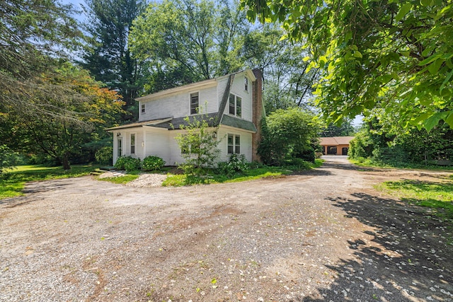 354 Black Rock Tpke, Easton, CT 06612 - view of side of home featuring a gambrel roof, view of scattered trees, and a chimney