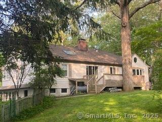 7 White Birch Rd, Wilton, CT 06897 - back of property featuring stairway, a deck, and a chimney