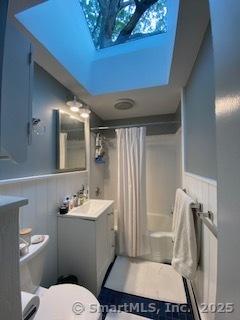 7 White Birch Rd, Wilton, CT 06897 - bathroom with vanity, a shower with shower curtain, a wainscoted wall, and a bath