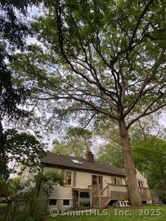 7 White Birch Rd, Wilton, CT 06897 - view of front facade with stairs, a front lawn, and a chimney