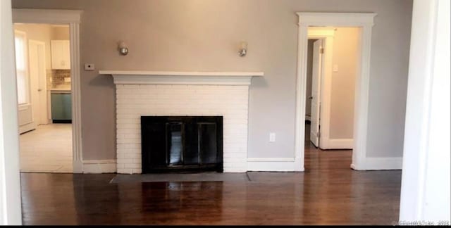 476 Park Ave, Bloomfield, CT 06002 - unfurnished living room featuring a fireplace and wood finished floors