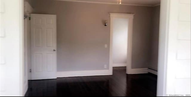 476 Park Ave, Bloomfield, CT 06002 - empty room with ornamental molding, baseboard heating, and wood finished floors