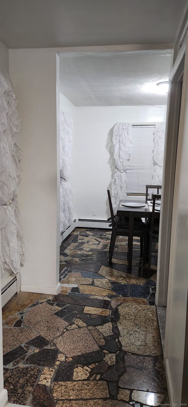 hall with a baseboard heating unit