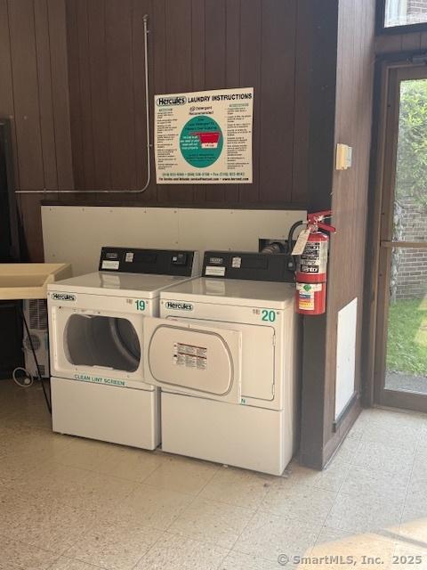 229 Bacon Pond Rd Apt 432, Woodbury, CT 06798 - community laundry room featuring wooden walls and washing machine and clothes dryer