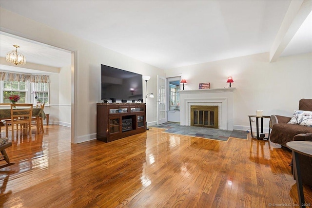12 Deacon Hill Rd, Stamford, CT 06905 - living area with a fireplace with flush hearth, hardwood / wood-style flooring, and a chandelier