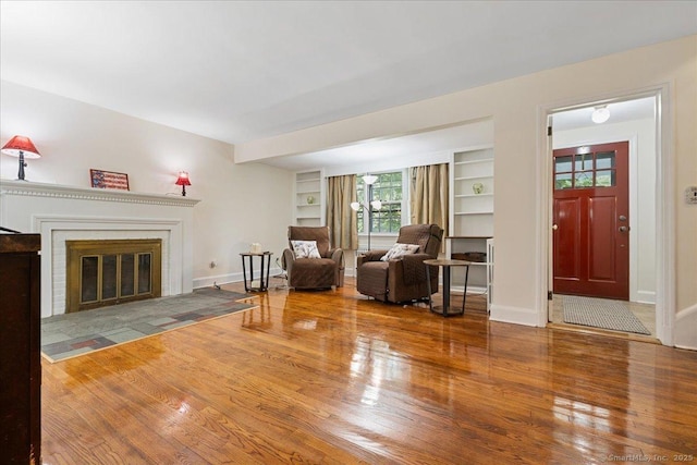 12 Deacon Hill Rd, Stamford, CT 06905 - living area featuring wood finished floors, a fireplace with flush hearth, and built in features