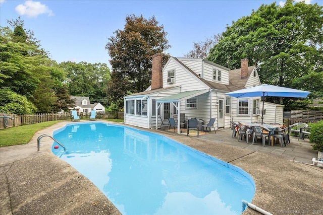 12 Deacon Hill Rd, Stamford, CT 06905 - view of pool featuring a sunroom, a fenced backyard, a patio, and view of wooded area
