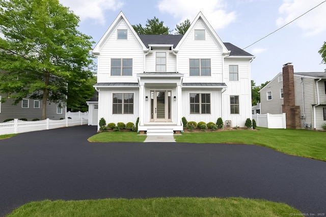1846 Mill Plain Rd, Fairfield, CT 06824 - view of front of home featuring board and batten siding, a standing seam roof, and a shingled roof