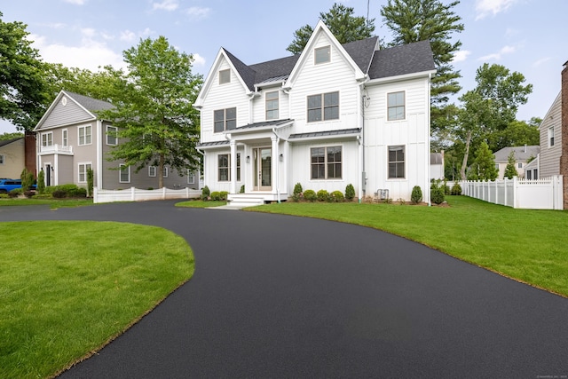1846 Mill Plain Rd, Fairfield, CT 06824 - view of front facade with board and batten siding, a standing seam roof, a metal roof, and roof with shingles