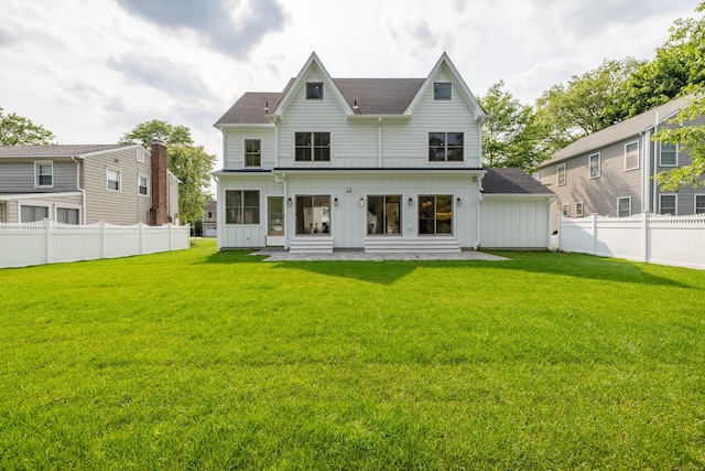 1846 Mill Plain Rd, Fairfield, CT 06824 - back of house with board and batten siding, a fenced backyard, and a shingled roof