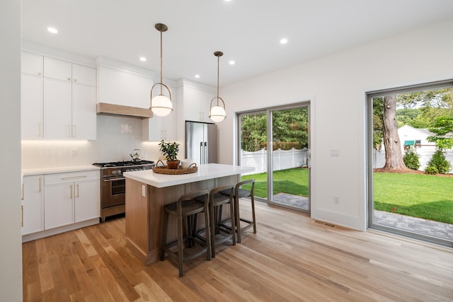 1846 Mill Plain Rd, Fairfield, CT 06824 - kitchen with stainless steel stove, freestanding refrigerator, light wood-style flooring, plenty of natural light, and recessed lighting