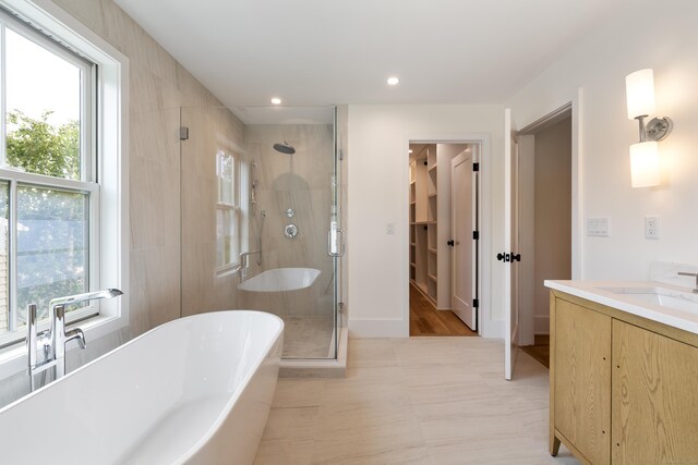 1846 Mill Plain Rd, Fairfield, CT 06824 - full bath featuring a stall shower, a freestanding bath, healthy amount of natural light, vanity, and recessed lighting