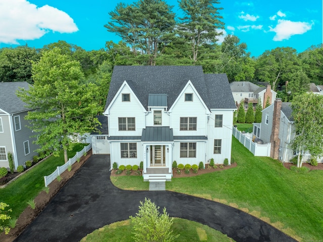 1846 Mill Plain Rd, Fairfield, CT 06824 - view of front facade featuring a standing seam roof, board and batten siding, asphalt driveway, a metal roof, and a shingled roof