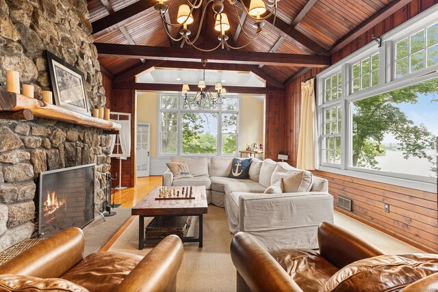 45 Lake Dr S, New Fairfield, CT 06812 - living area featuring a chandelier, wood ceiling, a stone fireplace, wooden walls, and wood finished floors