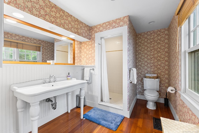 45 Lake Dr S, New Fairfield, CT 06812 - bathroom featuring hardwood / wood-style flooring, wallpapered walls, a shower stall, and a wainscoted wall