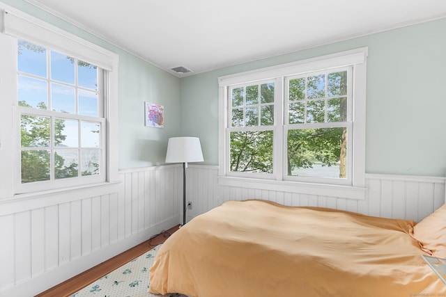 45 Lake Dr S, New Fairfield, CT 06812 - bedroom with wainscoting, wood finished floors, and crown molding