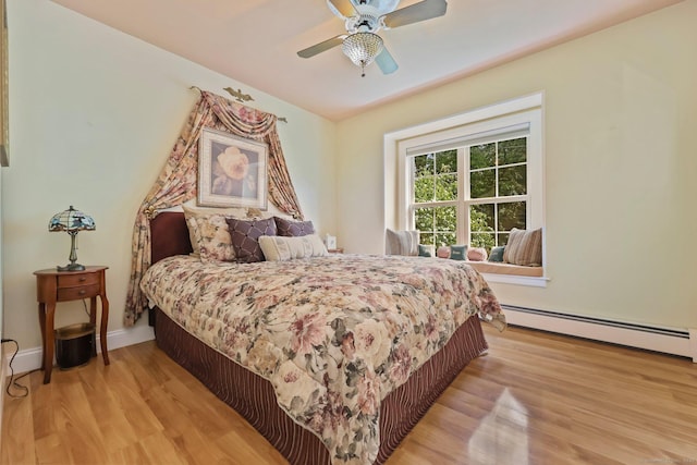 40 Pumpkin Ground Rd, Stratford, CT 06614 - bedroom with a baseboard heating unit, light wood-type flooring, and ceiling fan